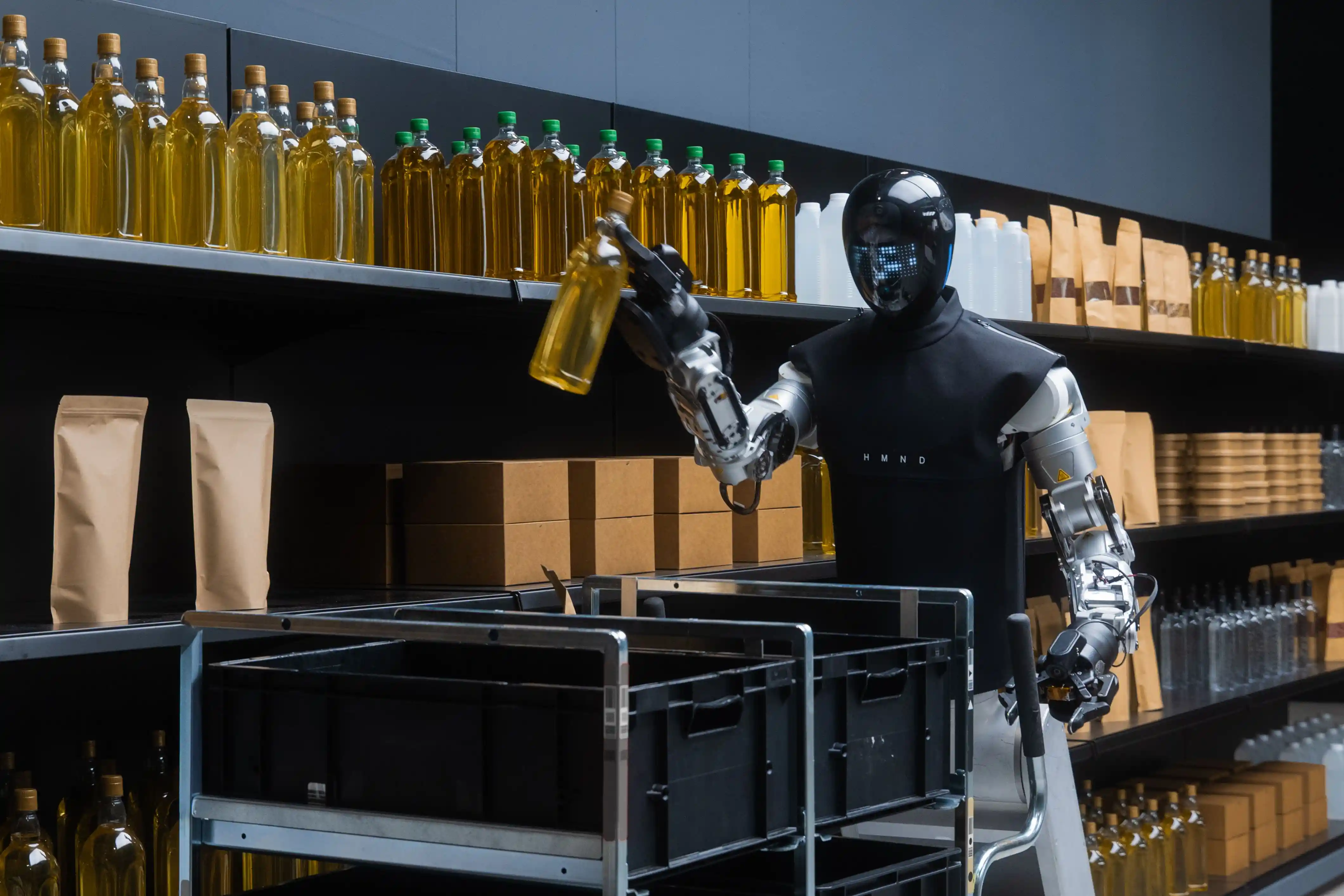 Humanoid robot moving warehouse totes along shelving